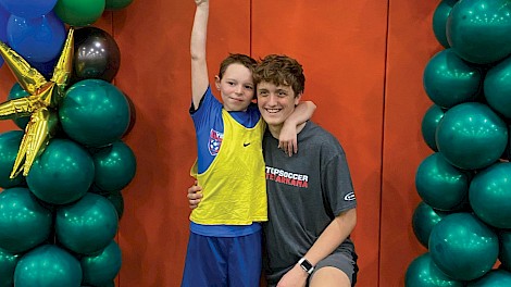 Texas High School volunteer Braden McKinnon with a TOPSoccer Texarkana athlete. photo by Dearborn Drone Co.