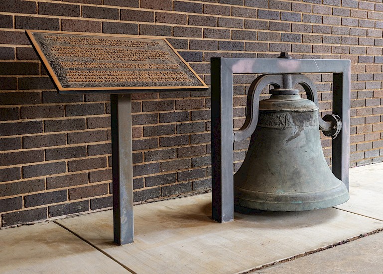 The restored bell from the 1957 fire now sits on the church's west side. Photo by Matt Cornelious