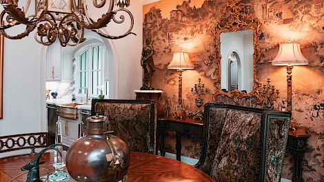 The formal dining room features hand-painted chinoiserie murals that resemble fine art.