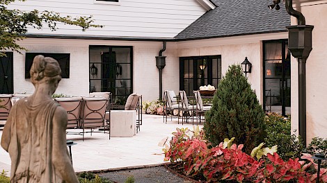 Custom metal shutters and awnings, designed by Kyle Barrett, add character to the exterior.