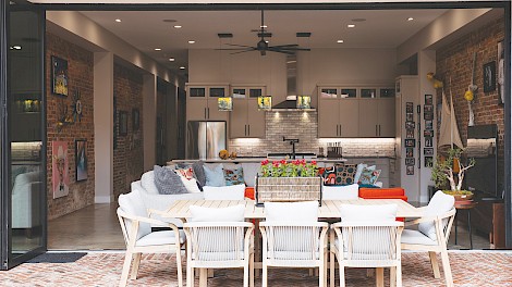 Panoramic folding doors open  the courtyard to the main living space,  creating a seamless indoor–outdoor flow.