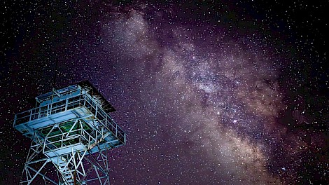 The night sky above a fire tower in Mena, Arkansas, captured by Don Riddle.