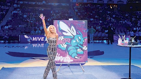 Haas performes a halftime speed painting for the NBA’s Charlotte Hornets in August 2024, captivating a crowd of 21,000 fans. photo courtesy of Jessica K. Haas