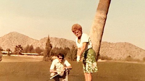 In 1984, Dorothy Langdon enjoys a round of golf during a break from the AirCo convention in Scottsdale, Arizona. Her son-in-law, Pete Snow, helping her line up the shot.
