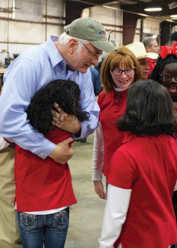 Steve Ledwell visits with children from Watersprings Ranch in 2018, highlighting Ledwell’s longstanding commitment to community involvement.
