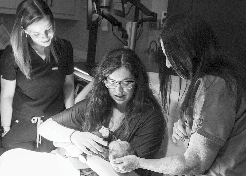 Midwives Brittany Nieves and Pamela Wyatt, with registered nurse and mother Candace Stine, after assisting with the delivery of her newborn son, Alex, at CHRISTUS St. Michael Hospital. Photo by Ginger Groben