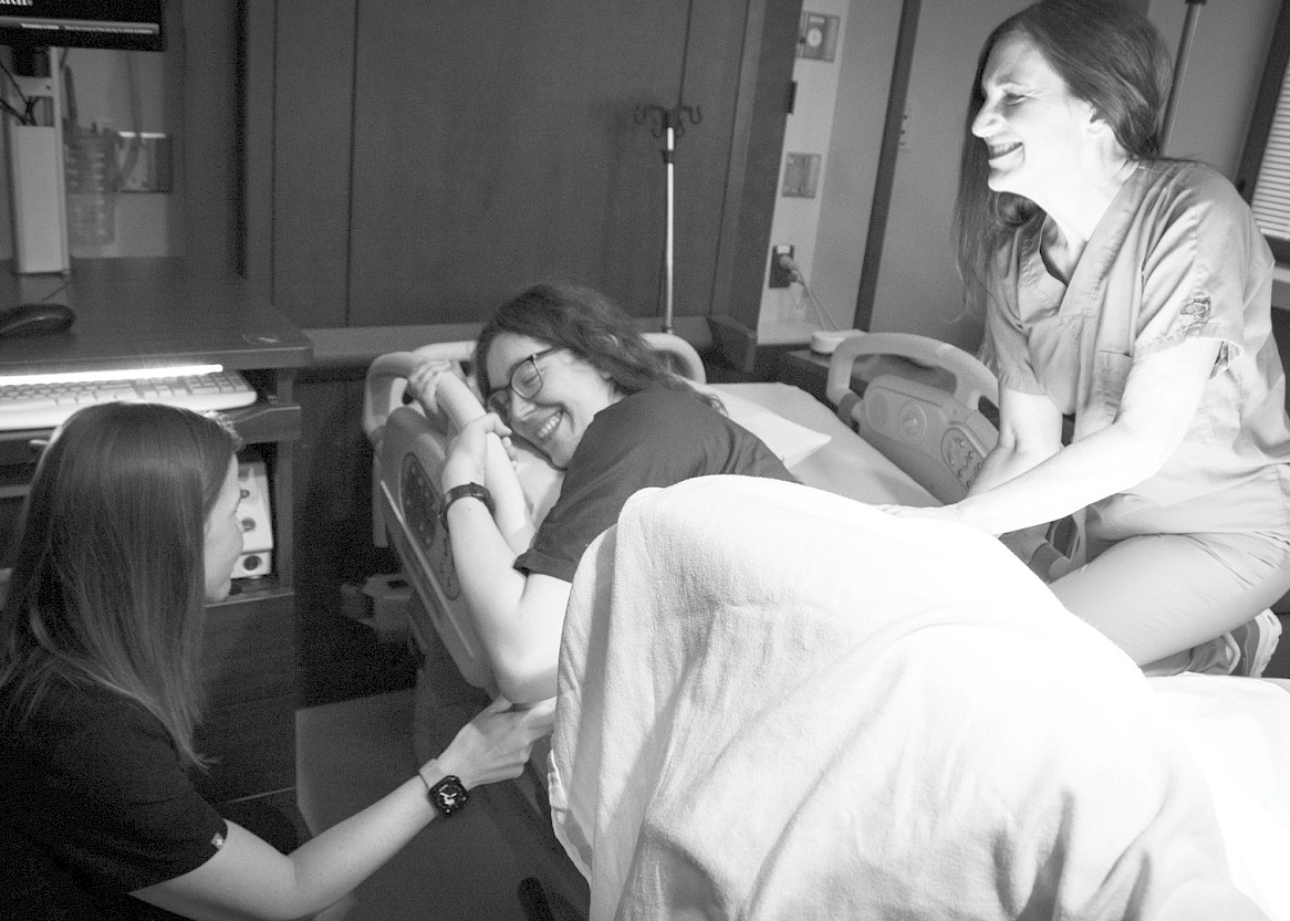 Candace Stine is supported by midwives Brittany and Pamela as she labors and prepares to welcome her newborn. Photo by Ginger Groben